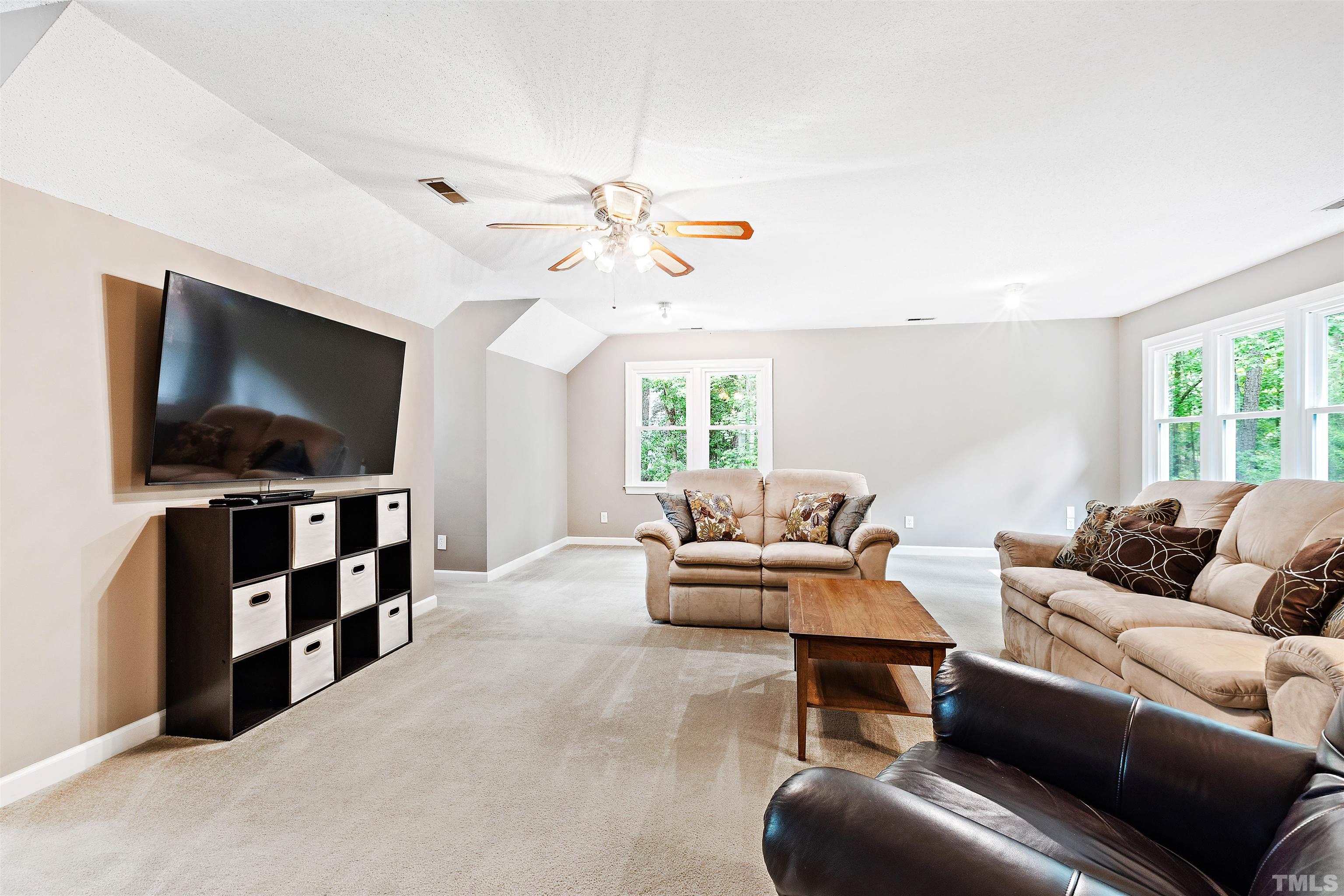 4708 Fallswood Place Raleigh, NC 27613 - Photo 35 of 45 a living room with furniture and a flat screen tv