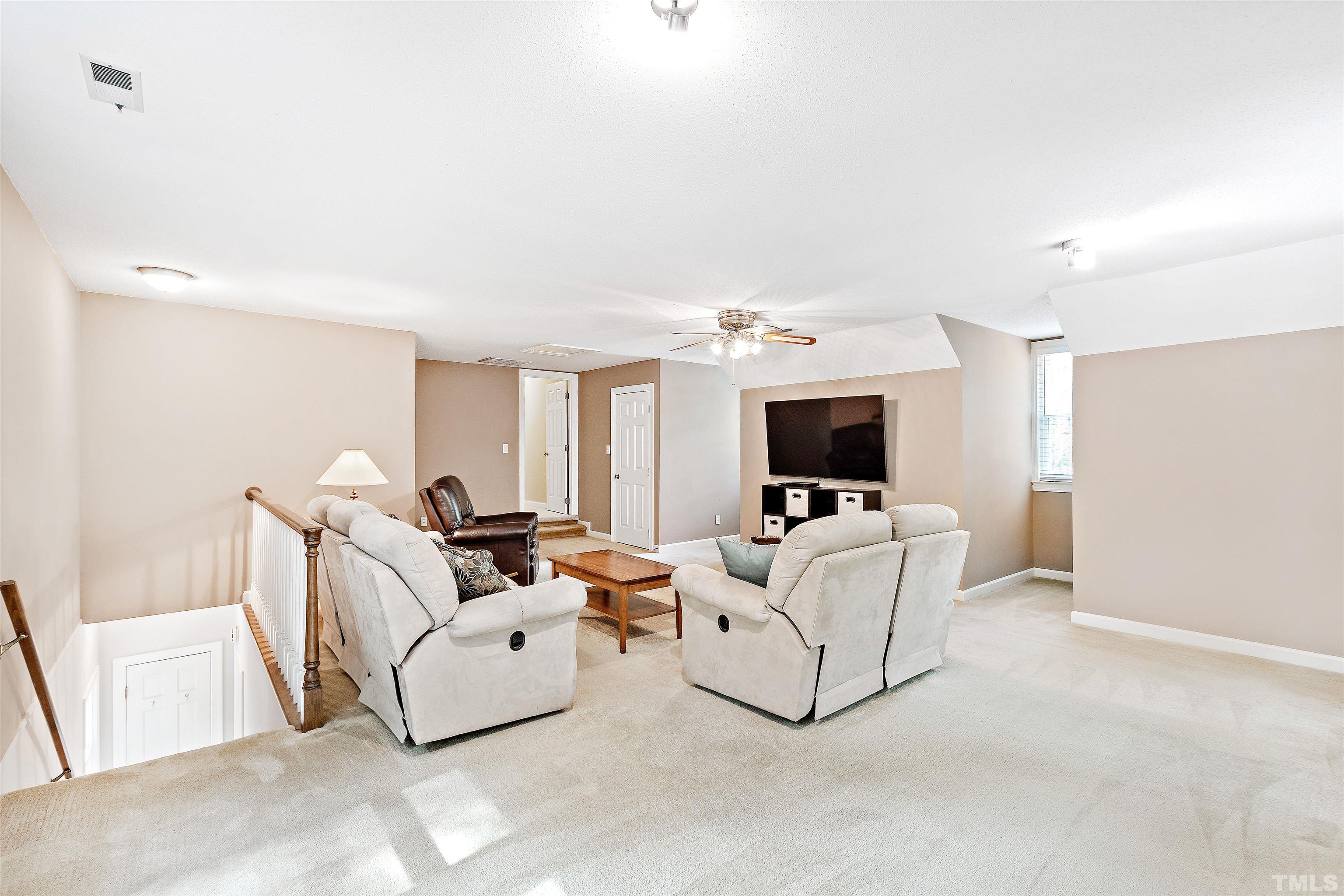 4708 Fallswood Place Raleigh, NC 27613 - Photo 37 of 45 a living room with furniture and a flat screen tv