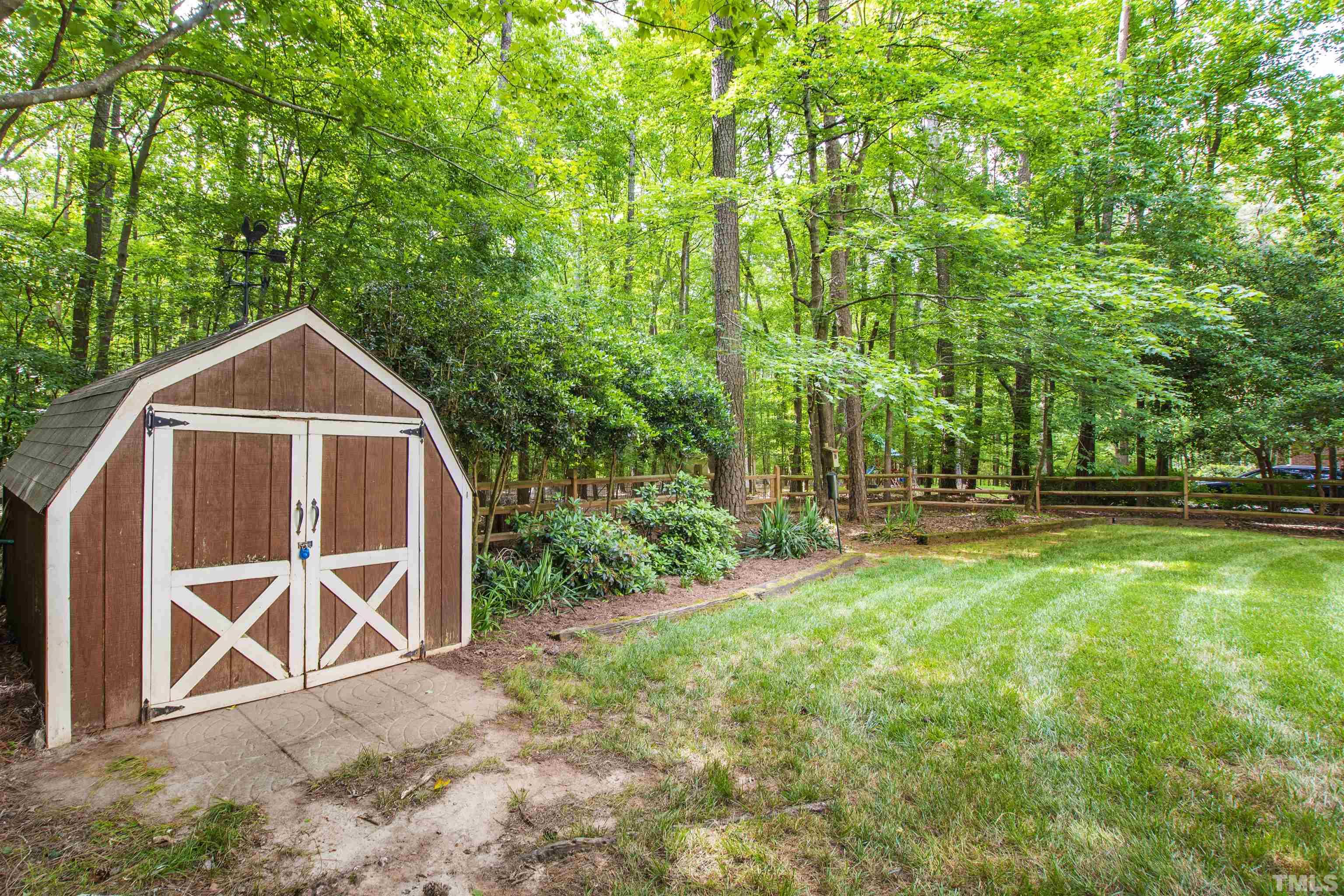 4708 Fallswood Place Raleigh, NC 27613 - Photo 43 of 45 a backyard of a house with table and chairs