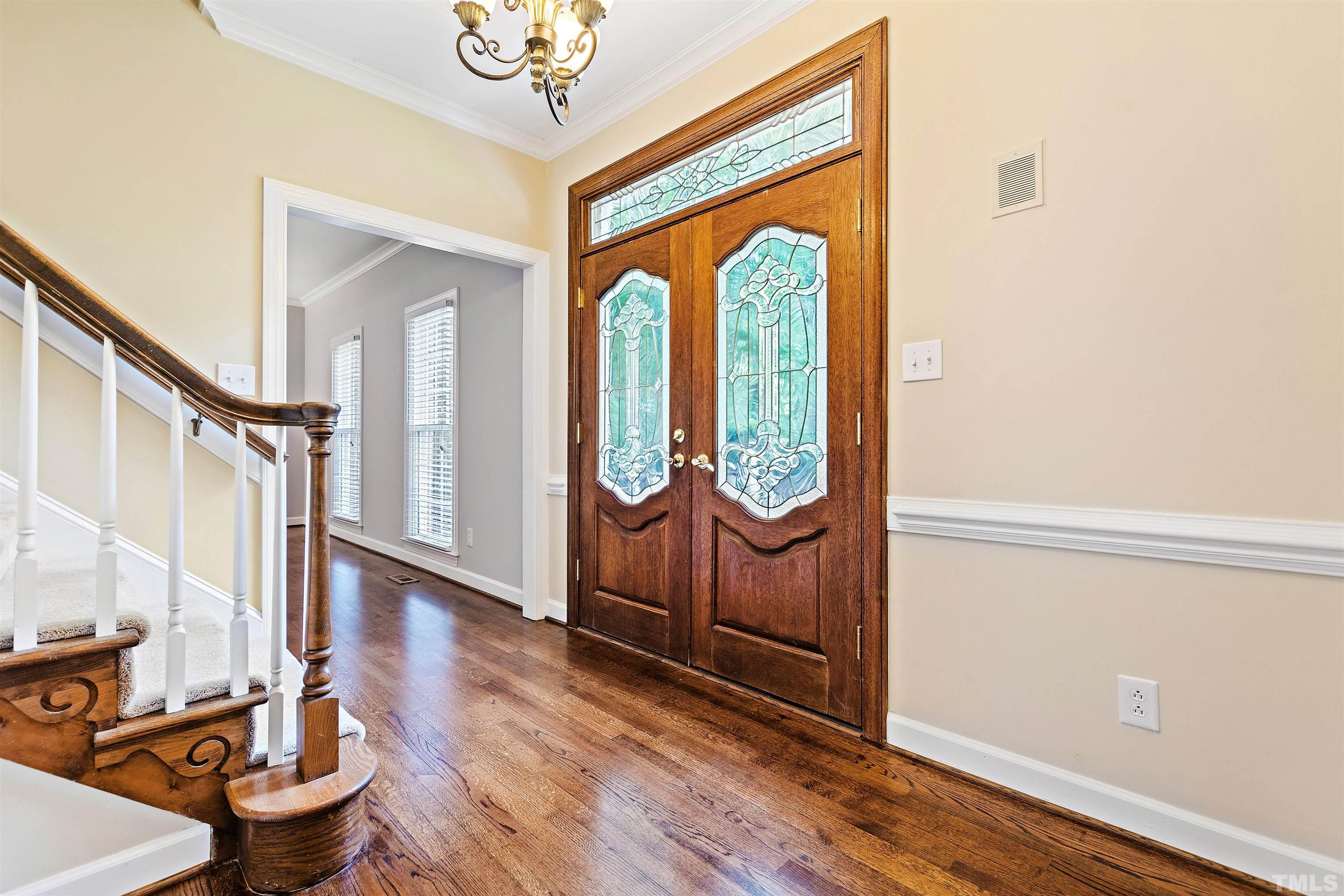 4708 Fallswood Place Raleigh, NC 27613 - Photo 5 of 45 a view of a entryway with wooden floor and door