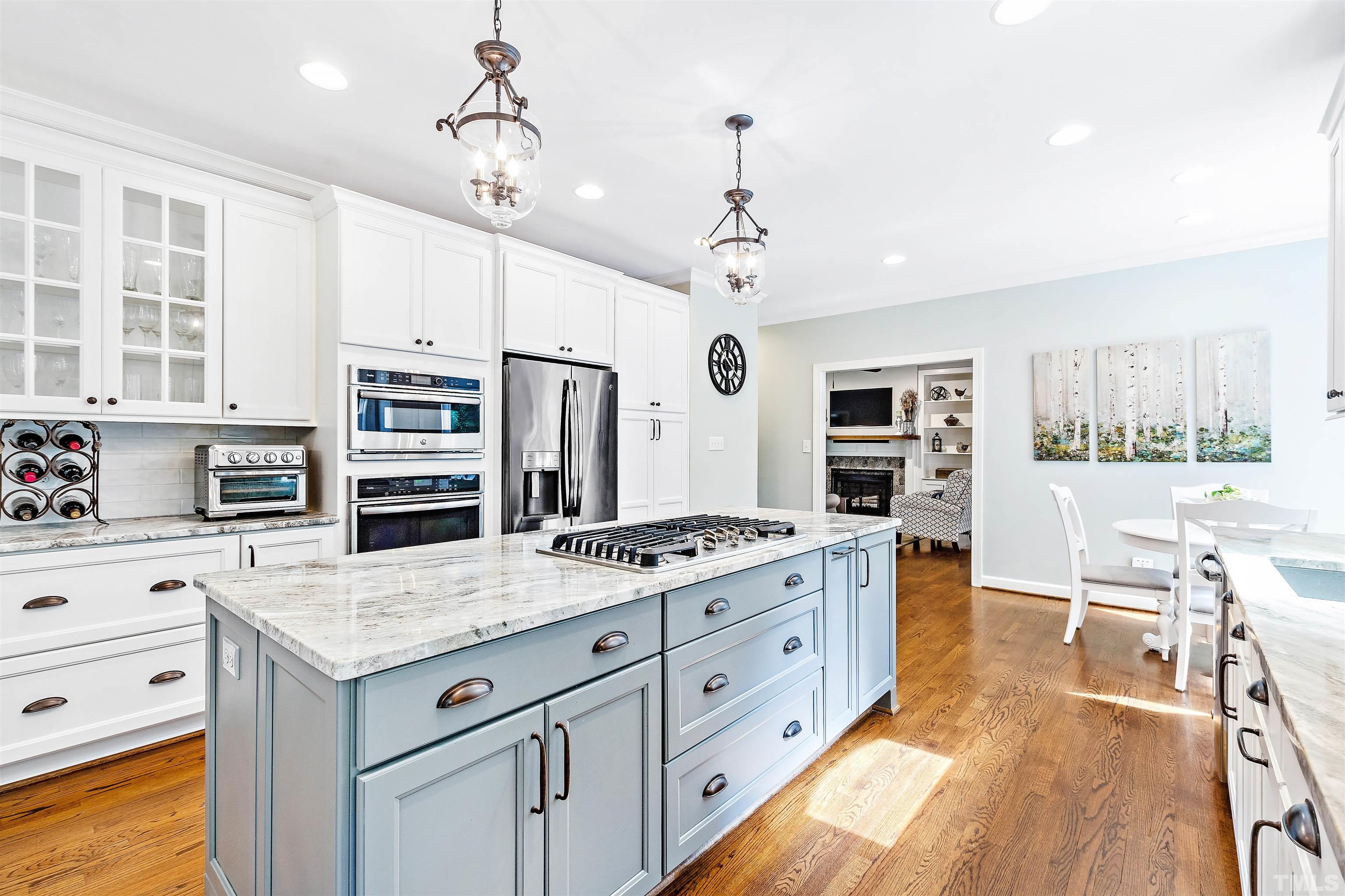 4708 Fallswood Place Raleigh, NC 27613 - Photo 6 of 45 a kitchen with stainless steel appliances granite countertop a stove oven and a view of living room
