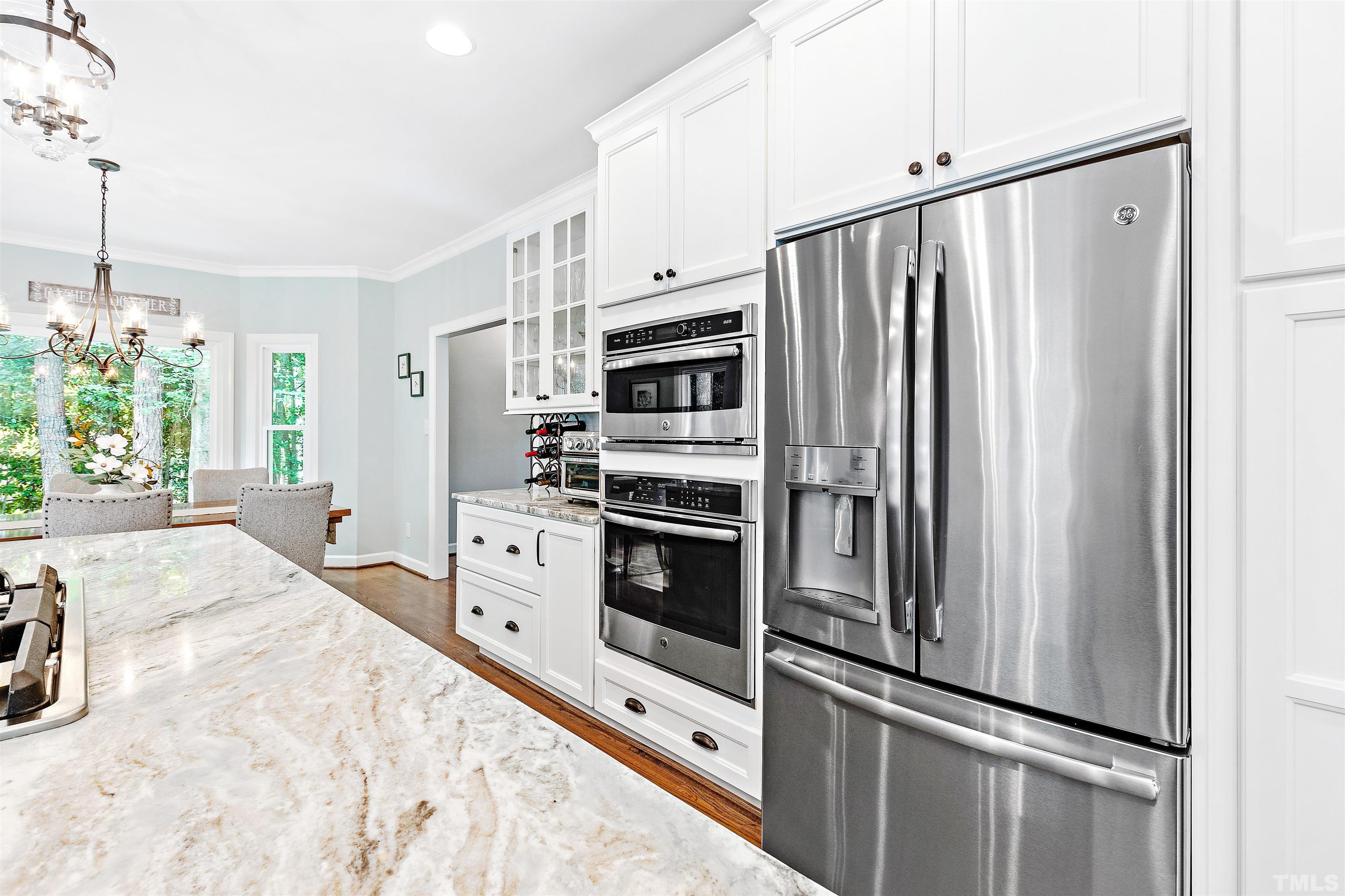 4708 Fallswood Place Raleigh, NC 27613 - Photo 10 of 45 a kitchen with stainless steel appliances a refrigerator sink and cabinets