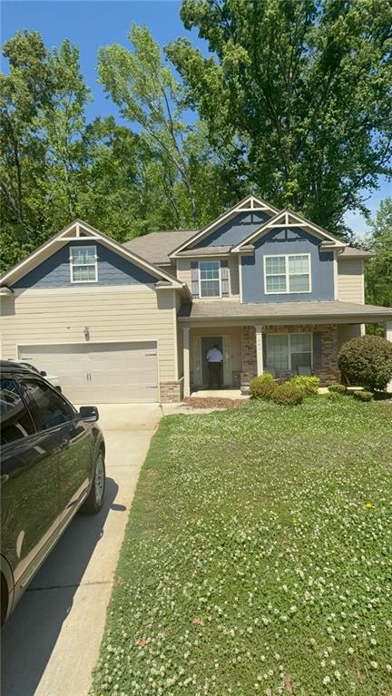 a front view of a house with a garden