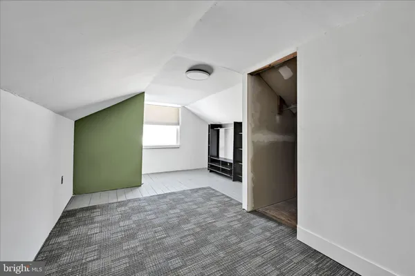 a view of a hallway with wooden shelves