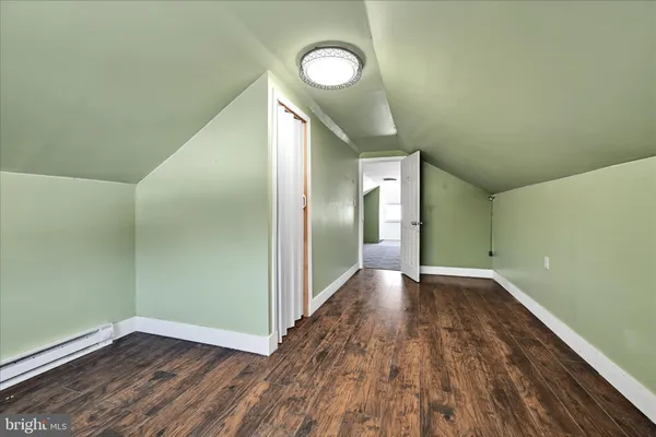 a view of a room with wooden floor and white walls