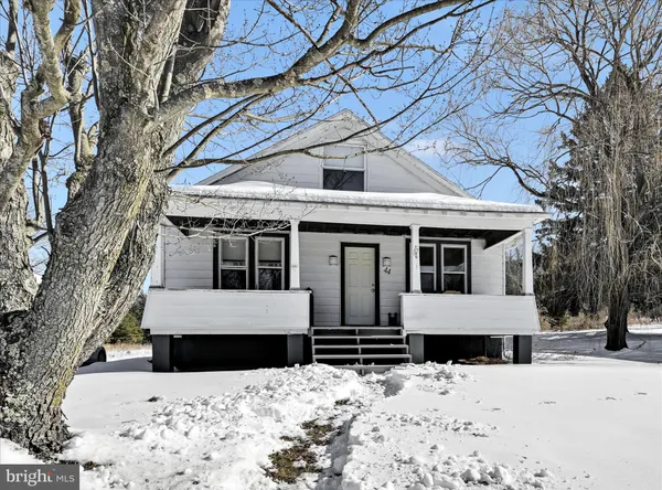 a front view of a house with a yard covered in snow