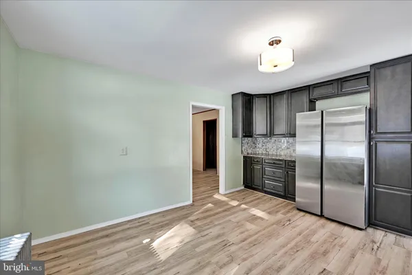 a view of a kitchen with a sink and a refrigerator