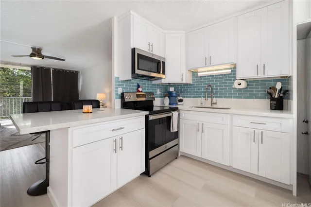 a kitchen with white cabinets and white appliances