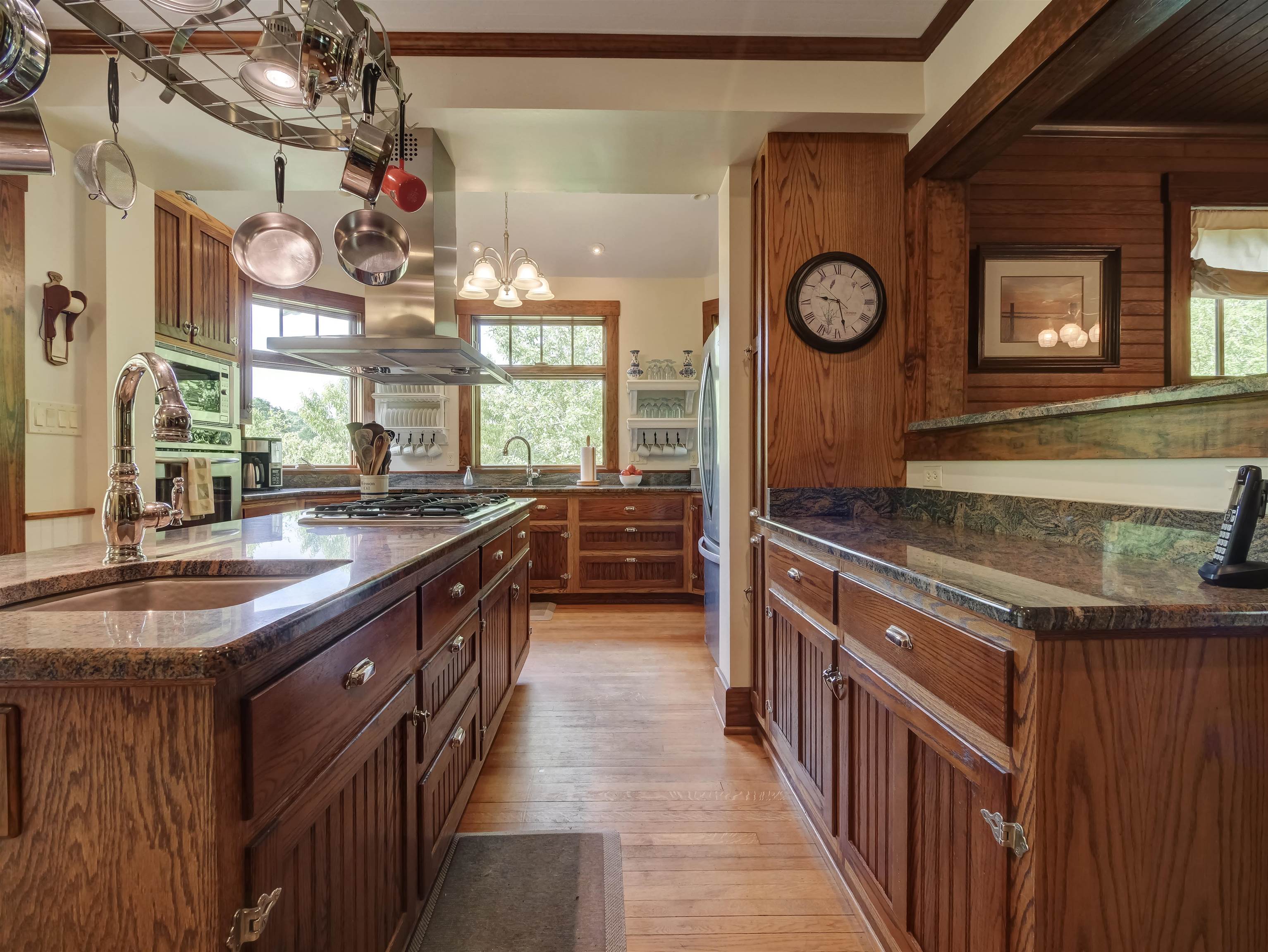 7304 Dry Run Road Williamsville, VA 24487 - Photo 22 of 57 a kitchen with kitchen island granite countertop a sink a stove top oven a clock and a window