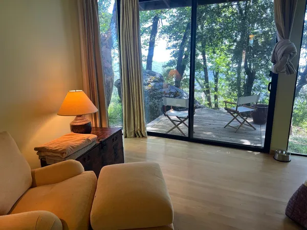 a living room with furniture and a floor to ceiling window