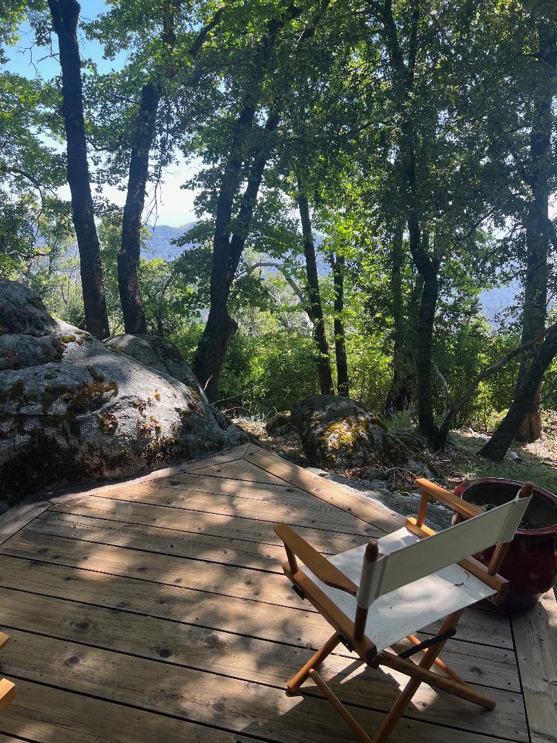 38875 Palo Colorado Road Carmel, CA 93923 - Photo 5 of 11 a view of a backyard with table and chairs and a large tree