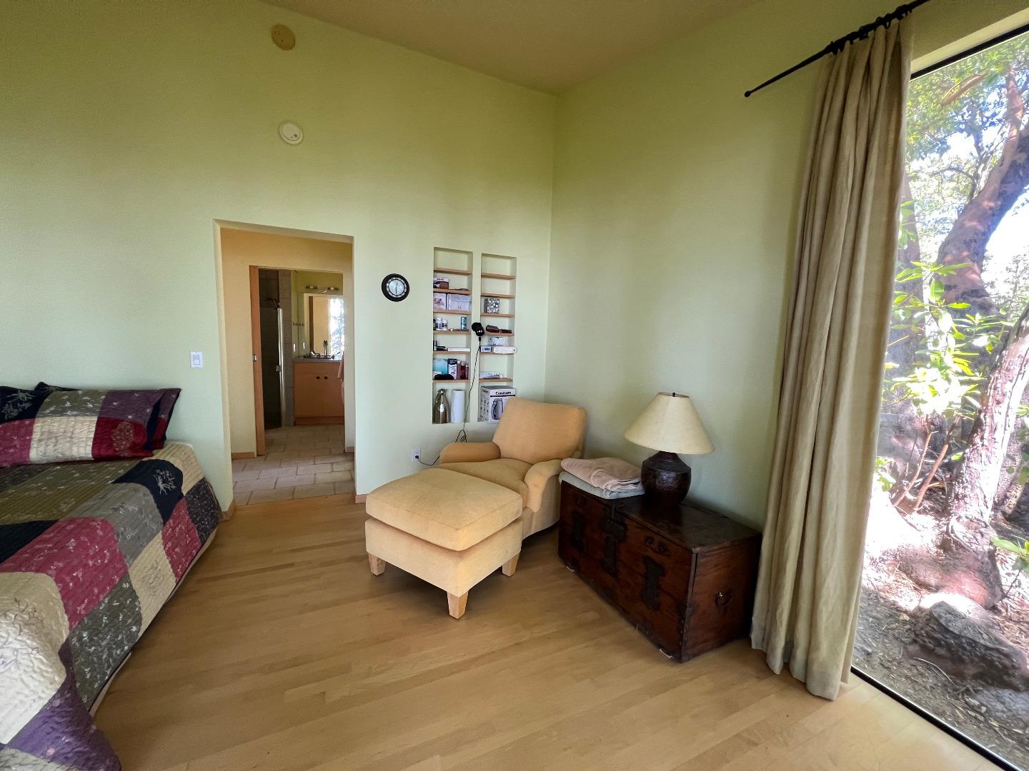 38875 Palo Colorado Road Carmel, CA 93923 - Photo 7 of 11 a spacious bedroom with a bed and a window