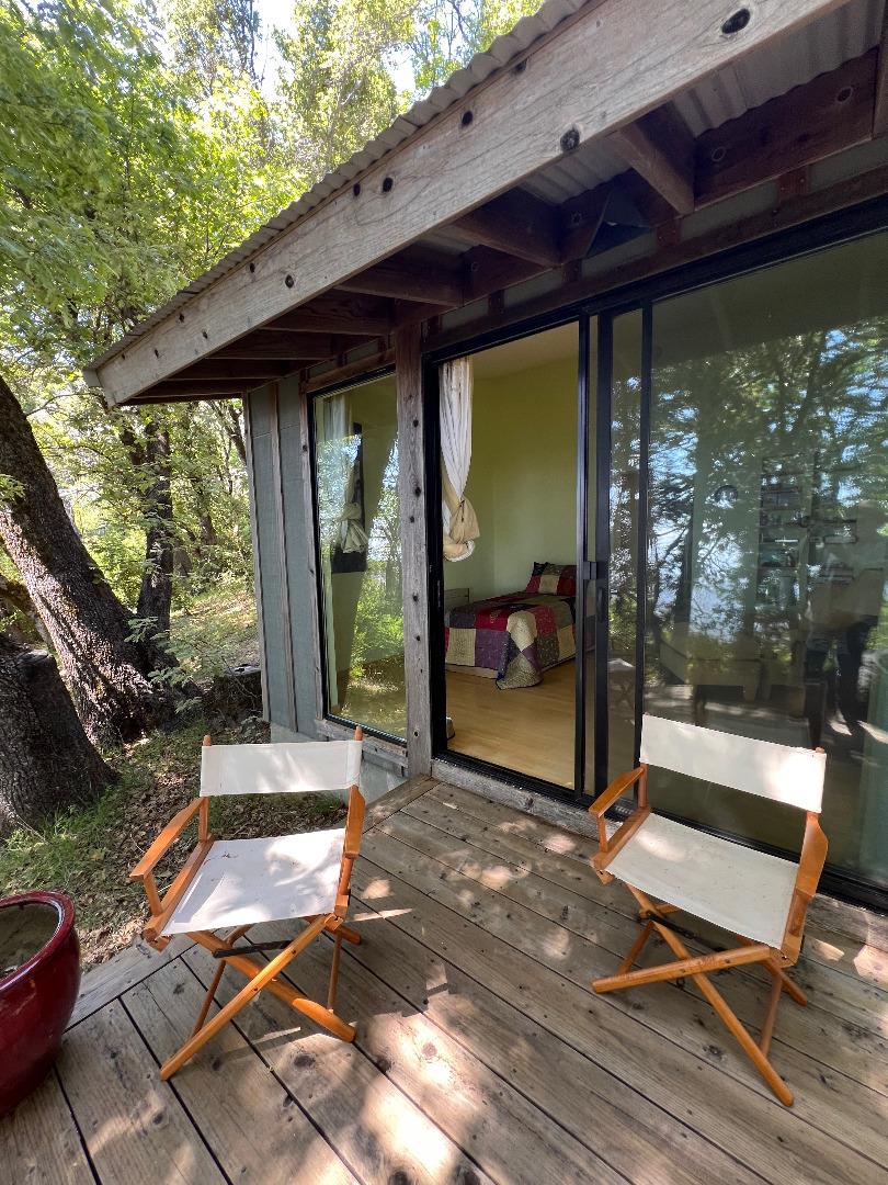38875 Palo Colorado Road Carmel, CA 93923 - Photo 9 of 11 a view of a patio with table and chairs next to a yard