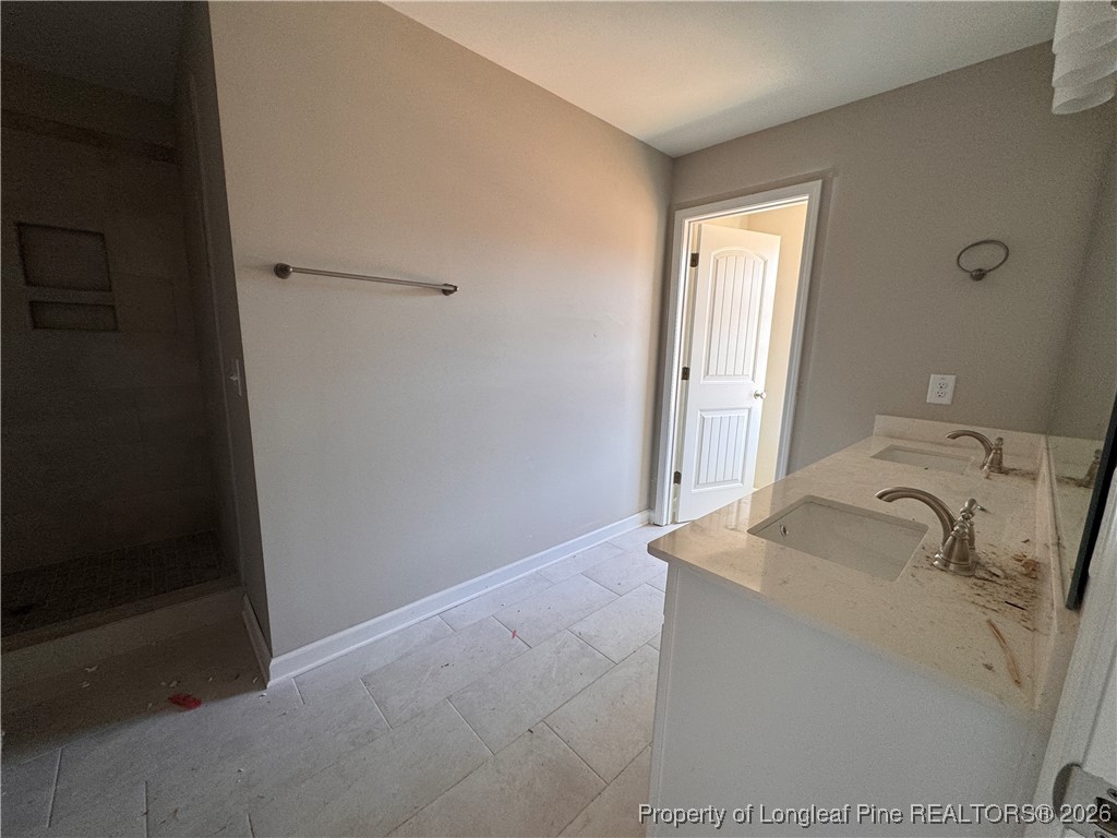 244 Rough Rdg Trail Aberdeen, NC 28315 - Photo 14 of 25 a bathroom with a sink and a mirror