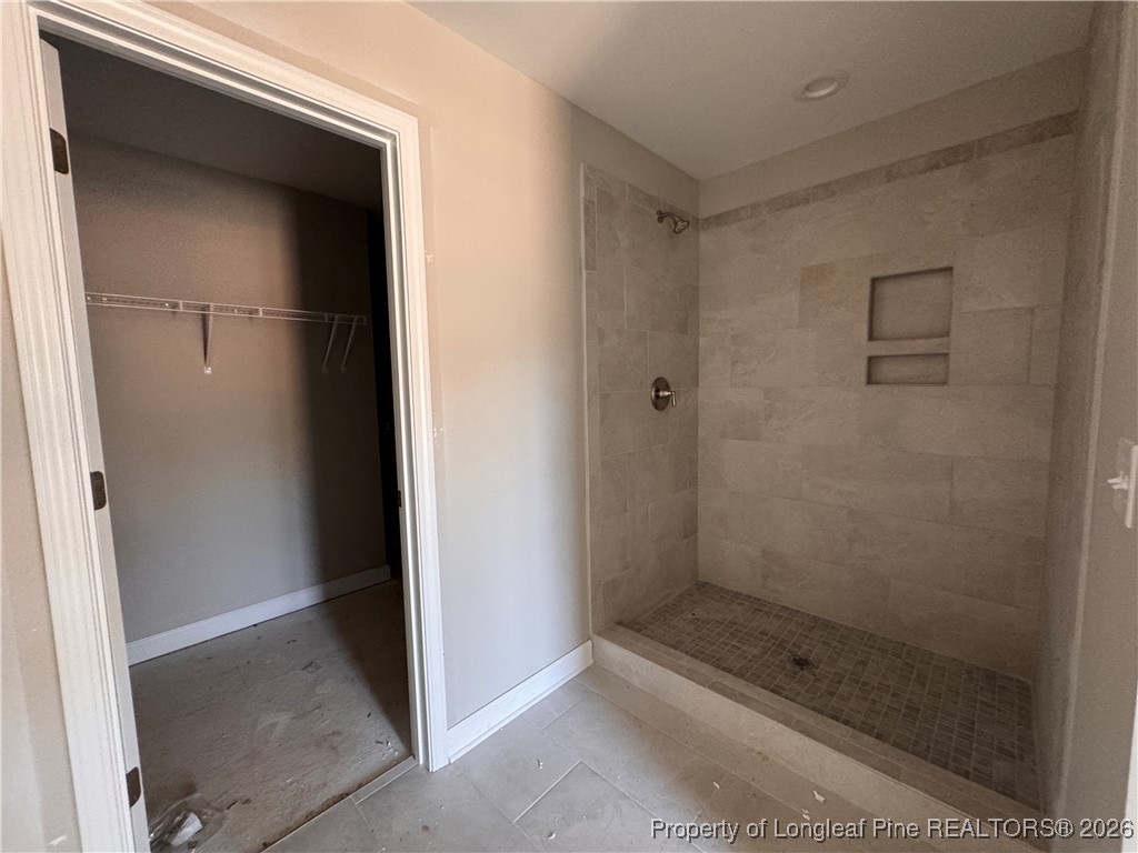 244 Rough Rdg Trail Aberdeen, NC 28315 - Photo 15 of 25 a bathroom with a glass shower door