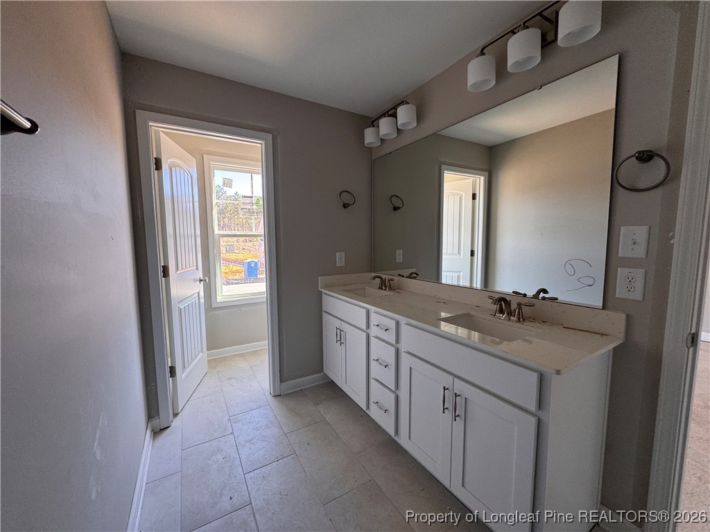 244 Rough Rdg Trail Aberdeen, NC 28315 - Photo 16 of 25 a spacious bathroom with a granite countertop sink a mirror and a