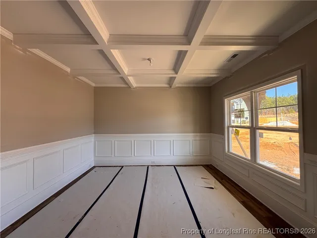 a view of wooden floor in a hall with a window
