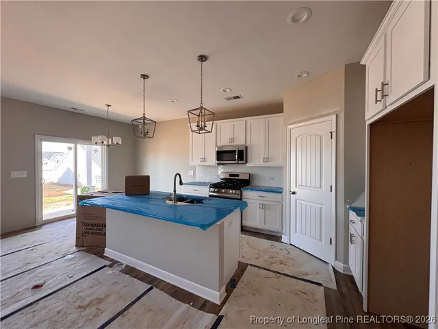 a kitchen with cabinets and appliances