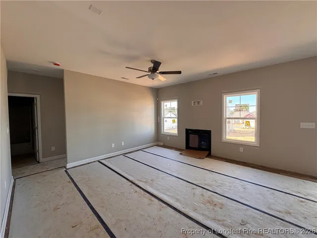 a view of a livingroom with a fireplace and window