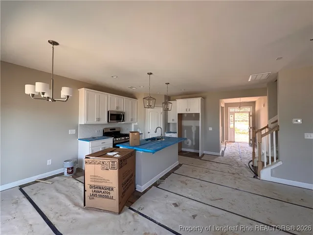 a kitchen with a refrigerator and a sink