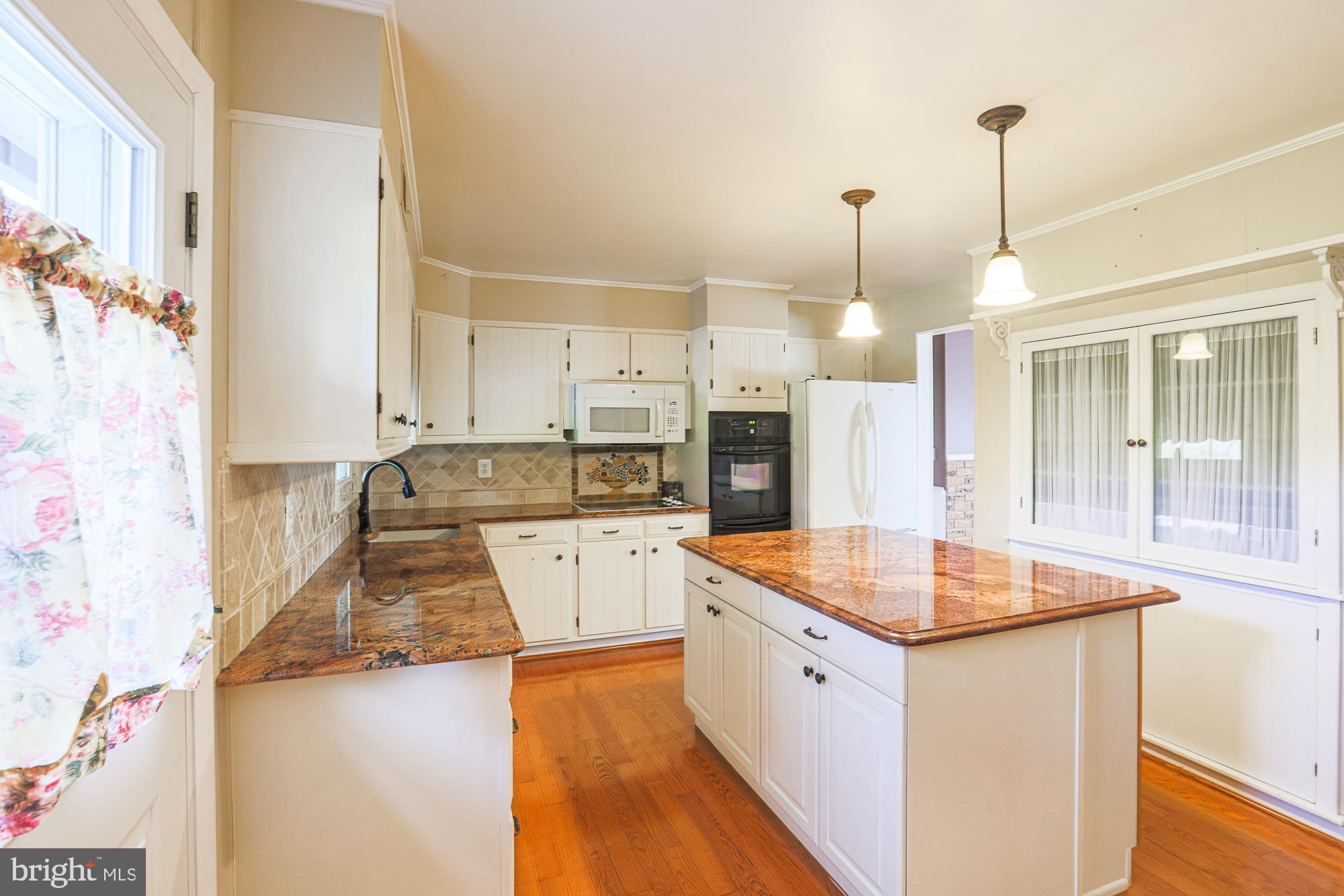 1522 Chivalry Court Rosedale, MD 21237 - Photo 11 of 36 a kitchen with stainless steel appliances granite countertop a sink stove and refrigerator