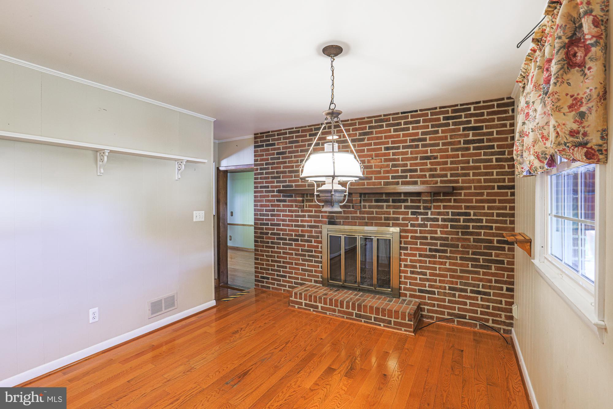 1522 Chivalry Court Rosedale, MD 21237 - Photo 12 of 36 a view of empty room with wooden floor and fan