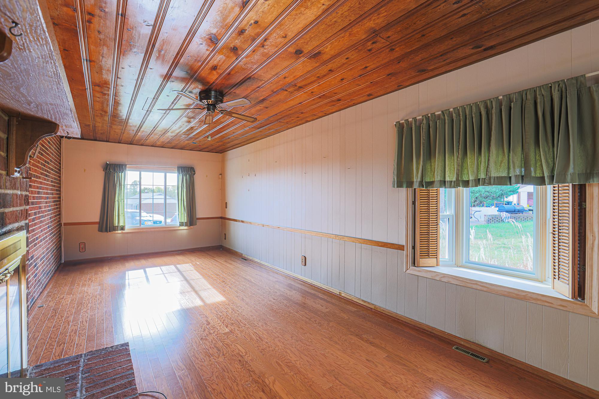 1522 Chivalry Court Rosedale, MD 21237 - Photo 14 of 36 a view of an empty room with wooden floor and a window