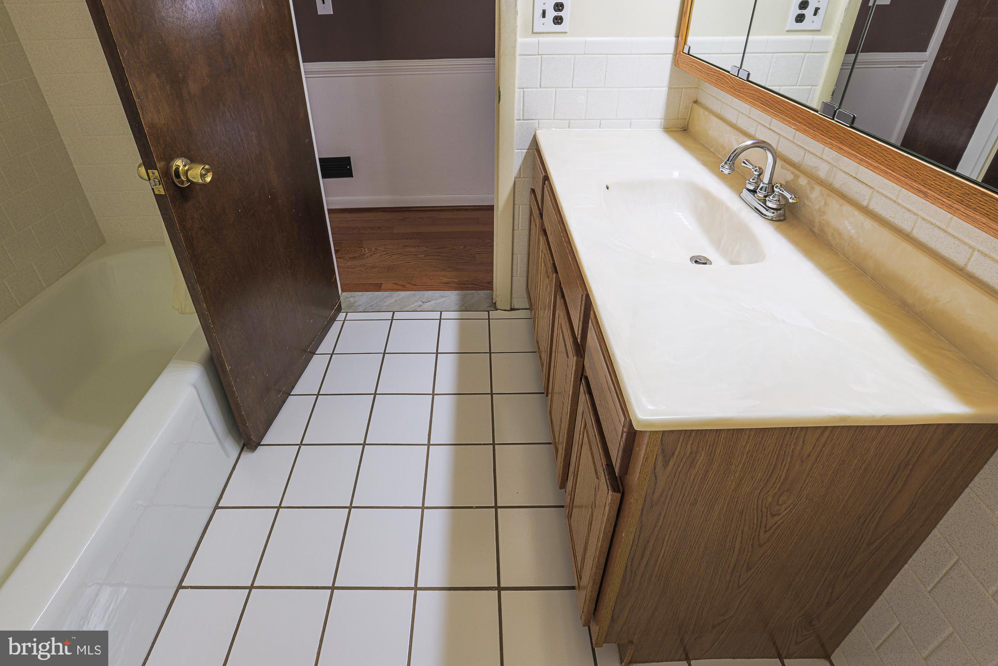 1522 Chivalry Court Rosedale, MD 21237 - Photo 23 of 36 a bathroom with a sink and a shower