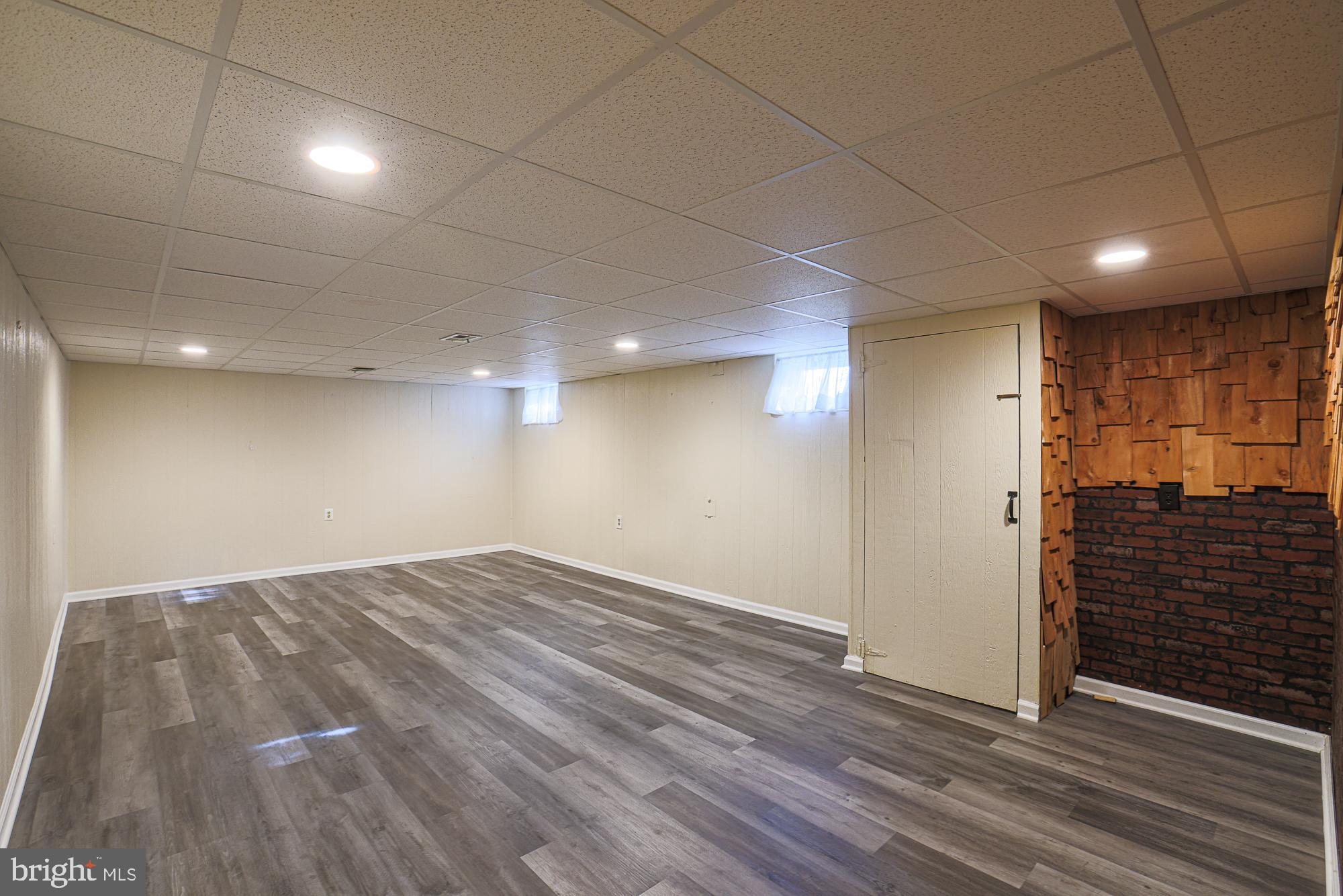 1522 Chivalry Court Rosedale, MD 21237 - Photo 24 of 36 a view of an empty room with wooden floor and a window