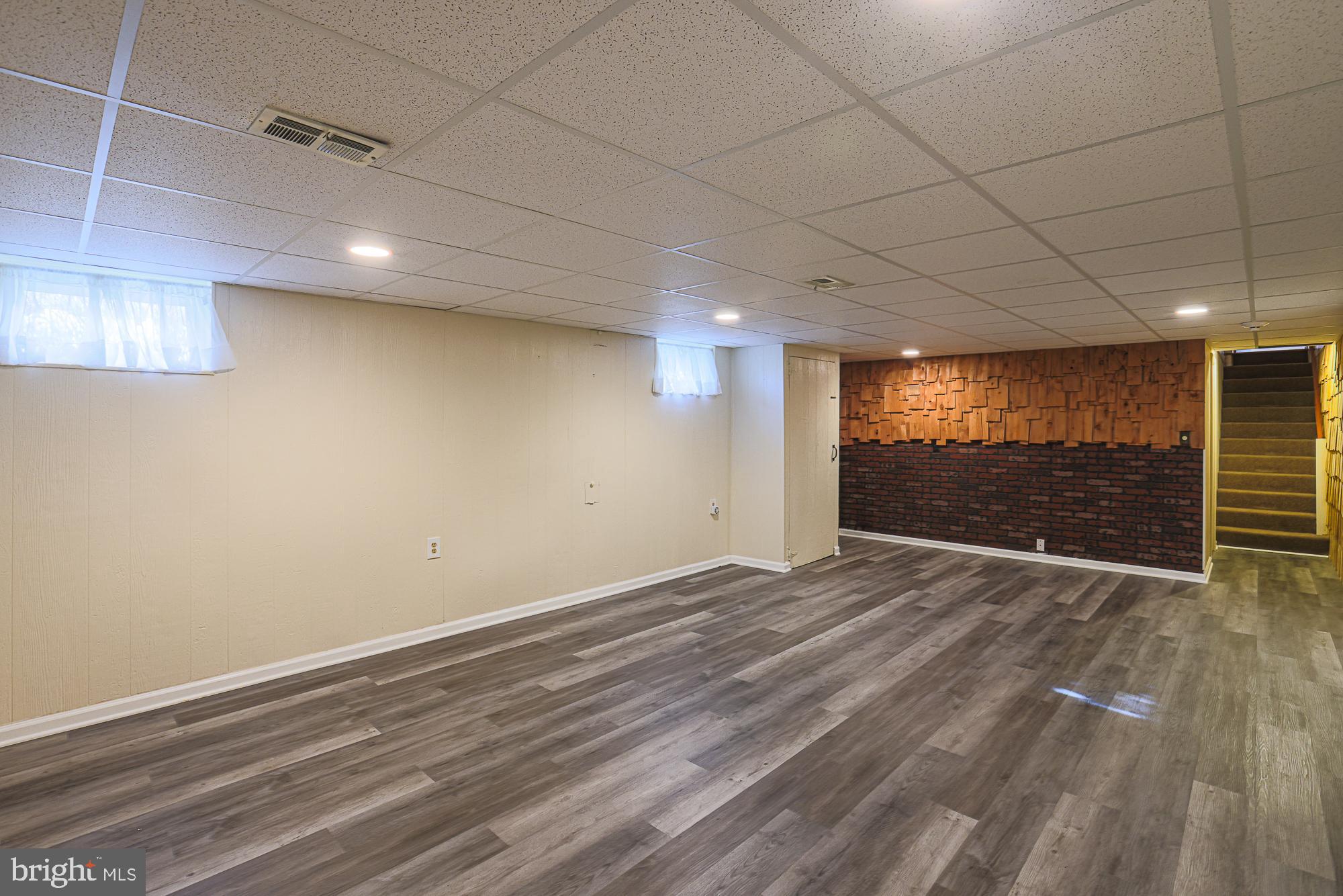 1522 Chivalry Court Rosedale, MD 21237 - Photo 26 of 36 an empty room with wooden floor and windows