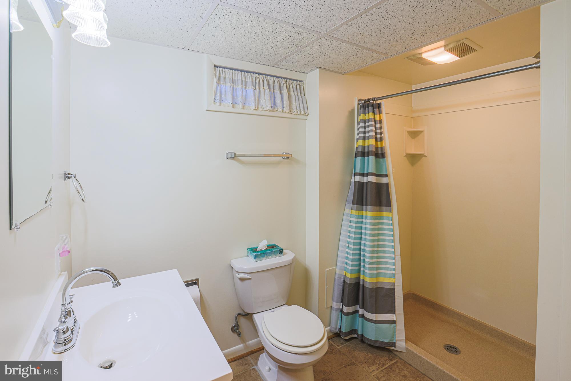 1522 Chivalry Court Rosedale, MD 21237 - Photo 29 of 36 a white toilet sitting next to a bathroom sink