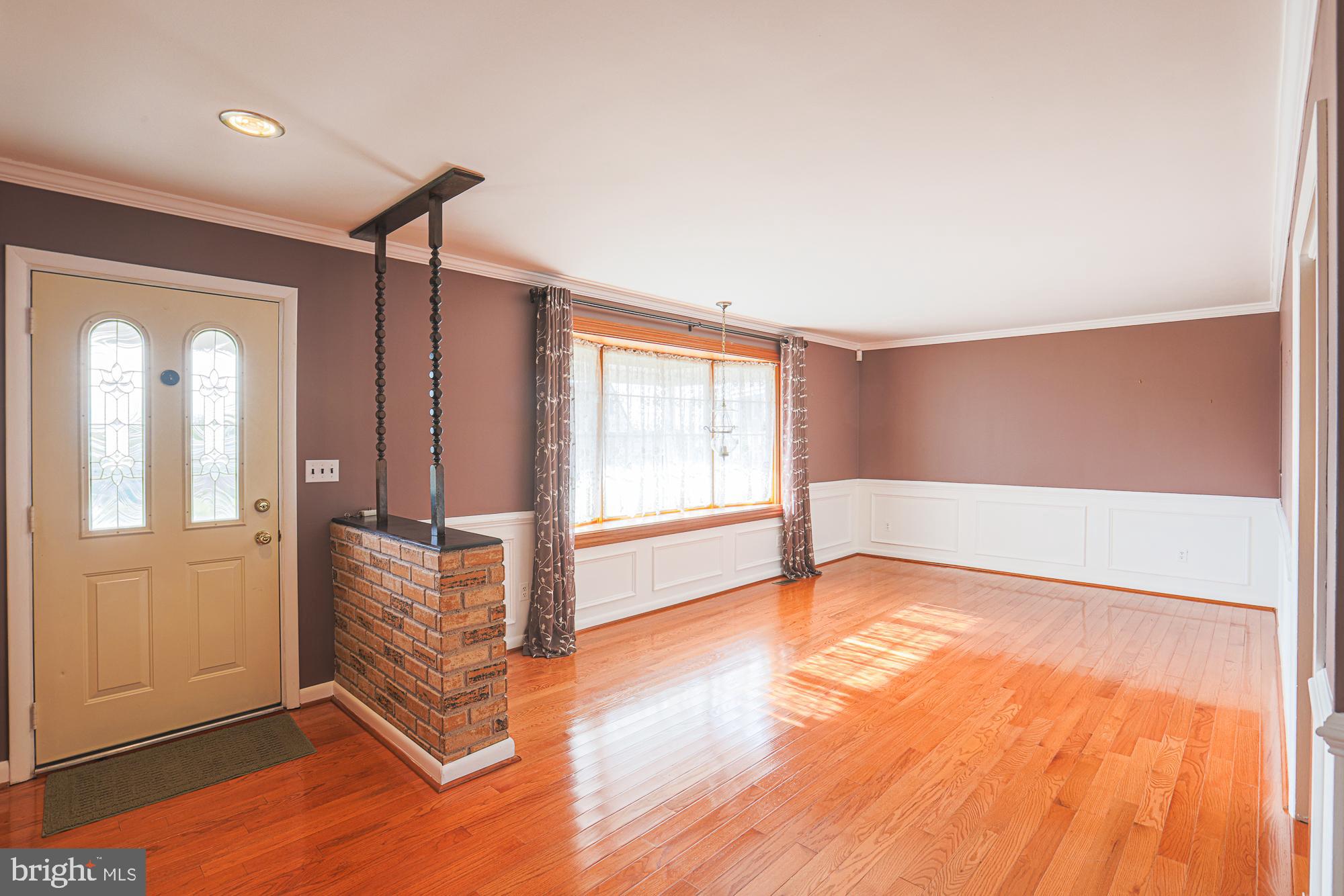 1522 Chivalry Court Rosedale, MD 21237 - Photo 5 of 36 a view of an empty room with glass door and wooden floor