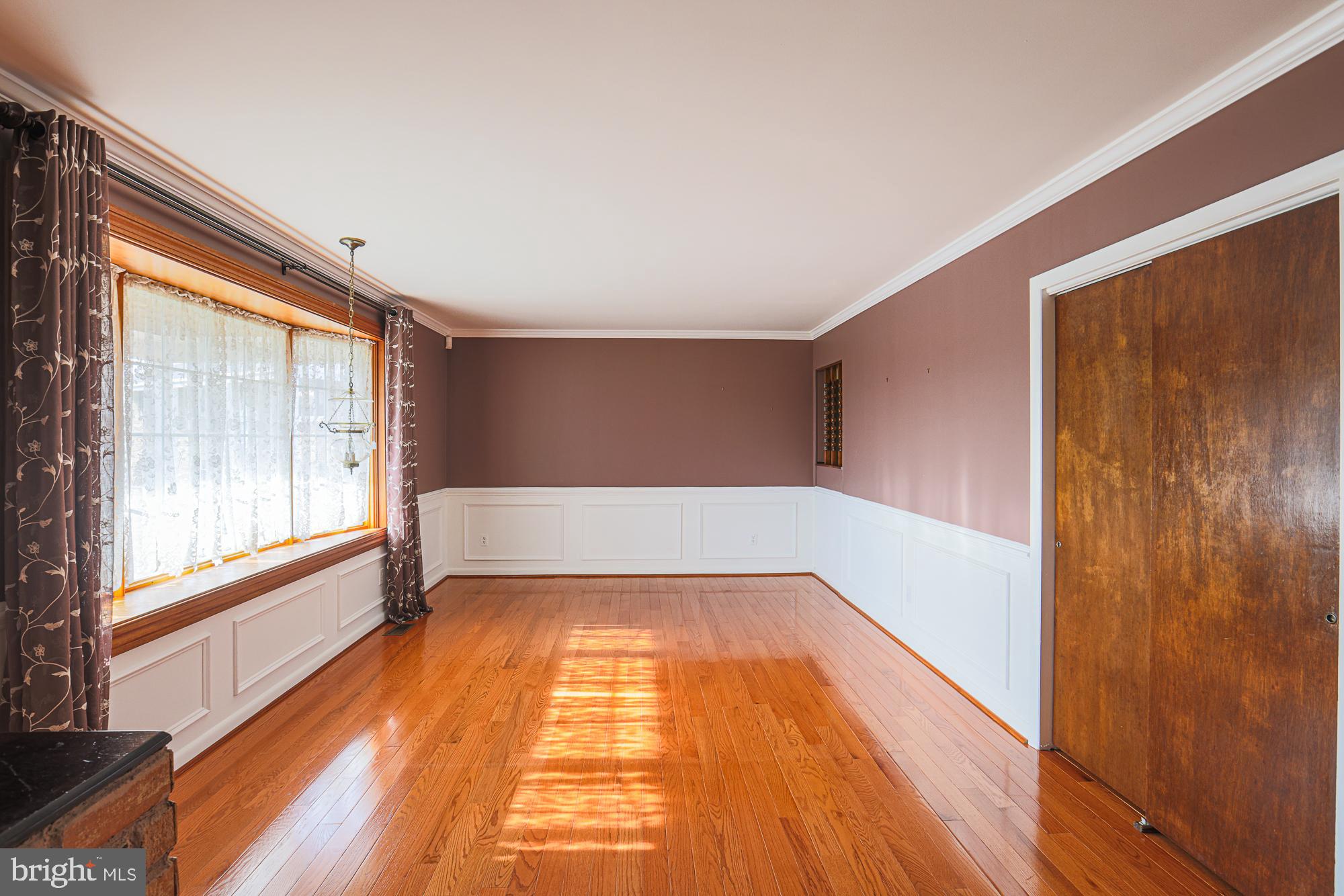 1522 Chivalry Court Rosedale, MD 21237 - Photo 7 of 36 a view of a big room with wooden floor and windows