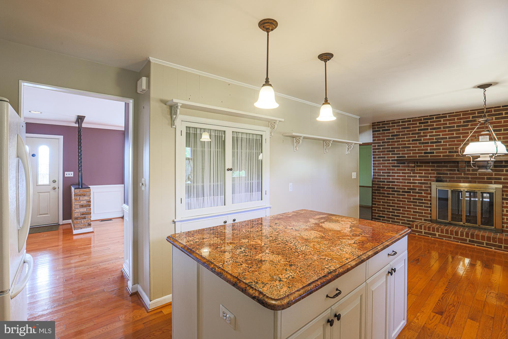 1522 Chivalry Court Rosedale, MD 21237 - Photo 8 of 36 a bathroom with a granite countertop sink and a refrigerator