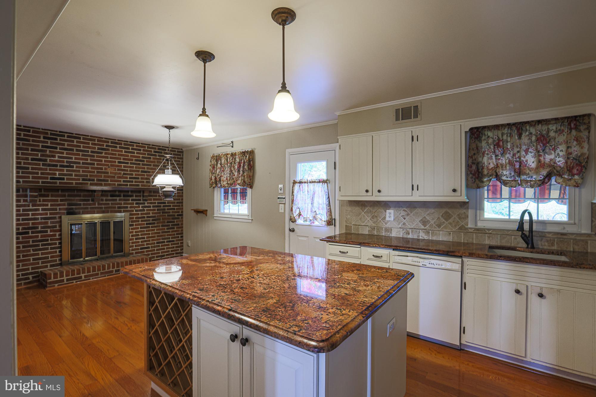 1522 Chivalry Court Rosedale, MD 21237 - Photo 9 of 36 a kitchen with kitchen island granite countertop a sink cabinets and wooden floor