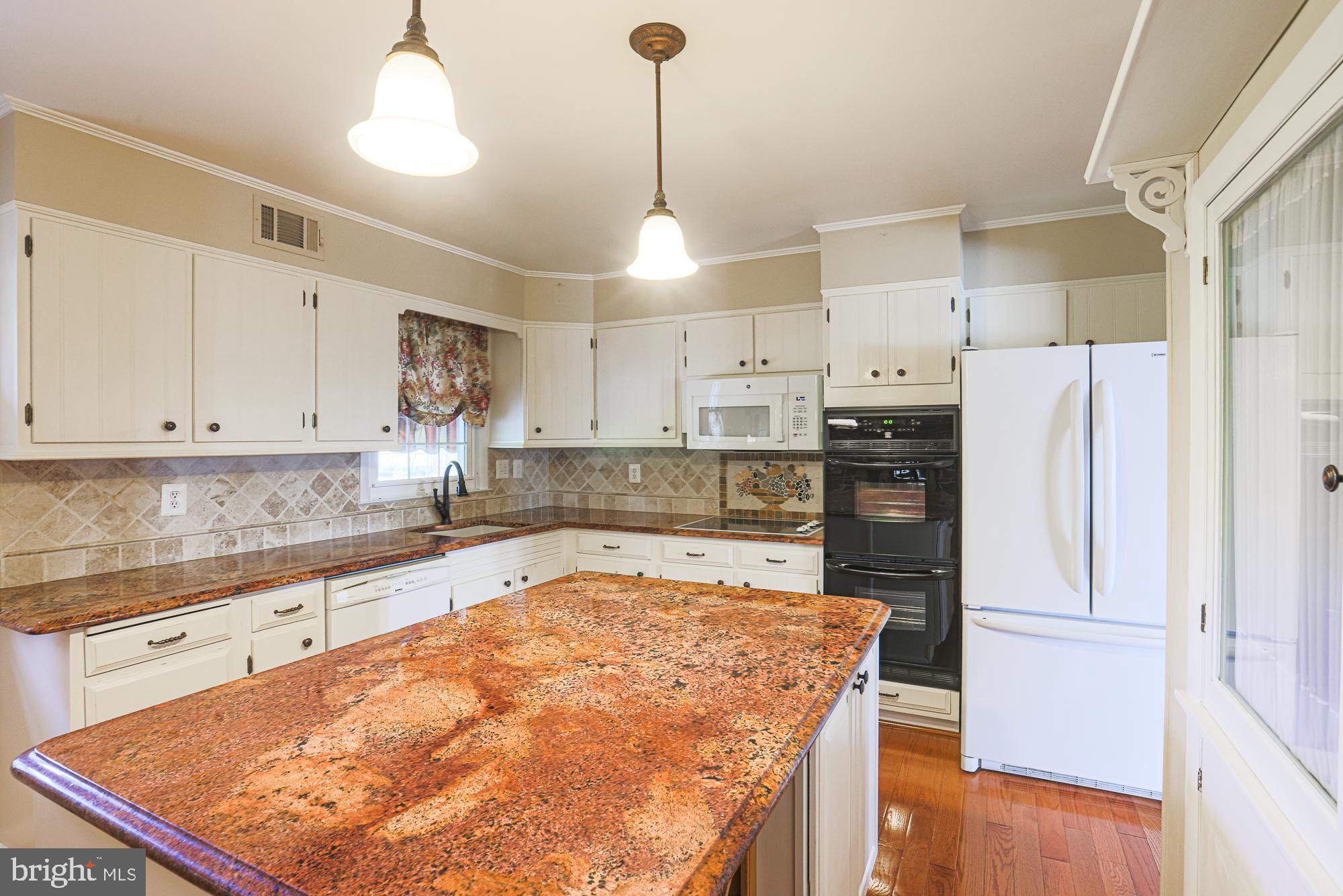 1522 Chivalry Court Rosedale, MD 21237 - Photo 10 of 36 a kitchen with stainless steel appliances granite countertop a refrigerator a sink and a stove