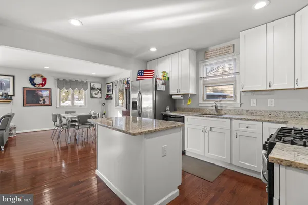 a kitchen with counter top space and wooden floor
