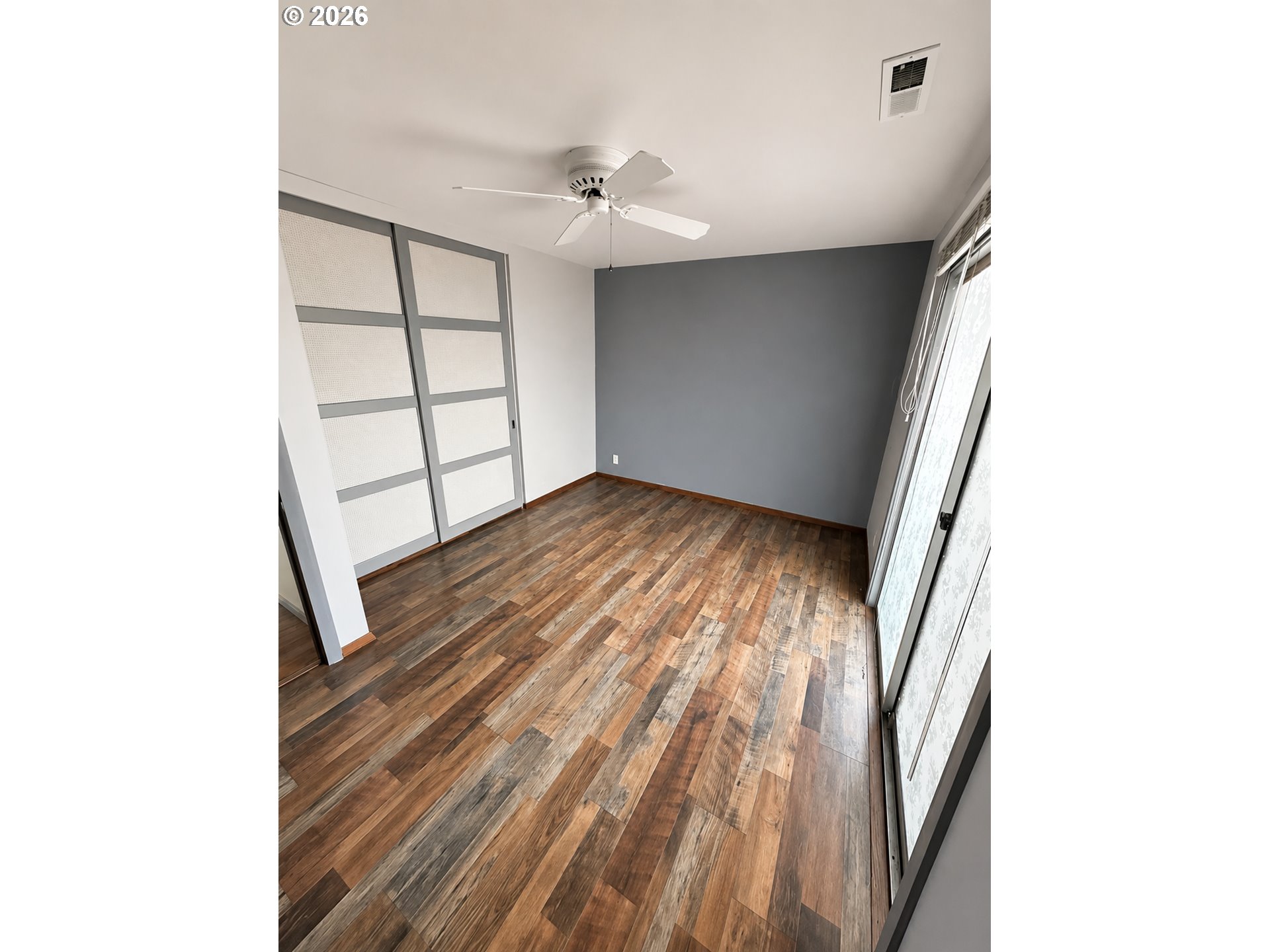 10 Southwest Peach Lane Winston, OR 97496 - Photo 19 of 22 a view of an empty room with wooden floor and a window