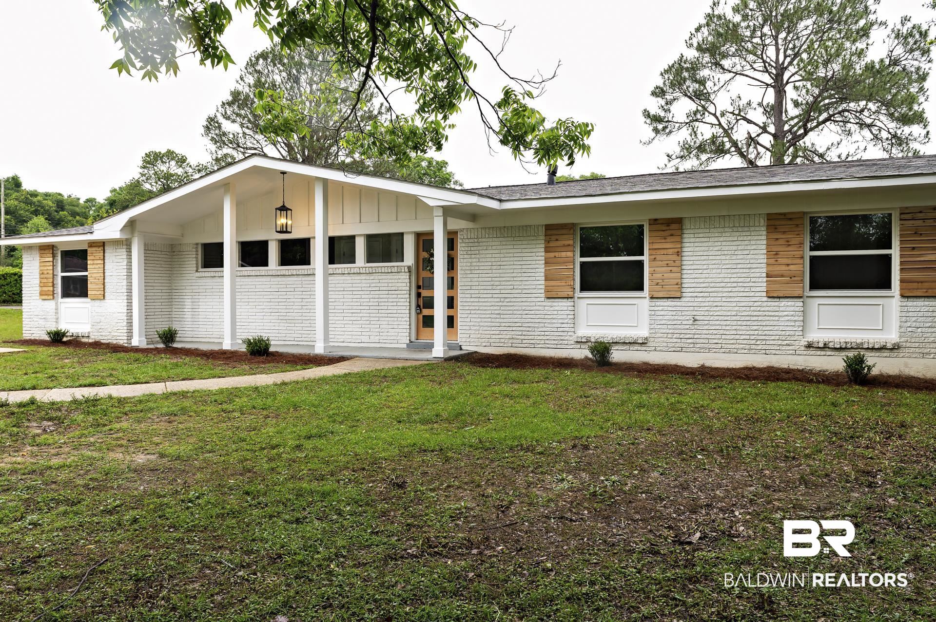 5922 Sunnyside Drive Mobile, AL 36619 - Photo 49 of 51 View of front of property with brick siding, a front lawn, and board and batten siding