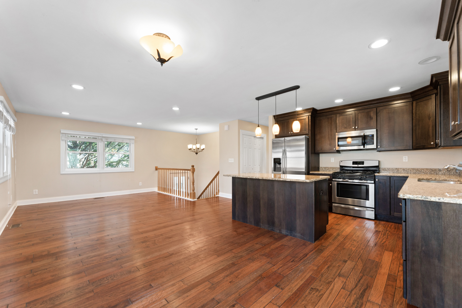 25 5n568 Il Rte Street St. Charles, IL 60174 - Photo 7 of 30 a kitchen with stainless steel appliances kitchen island granite countertop a stove top oven a sink dishwasher a refrigerator and a dining table with wooden floor