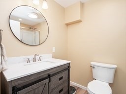 374 Great Road, Unit 11 Acton, MA 01720 - Photo 20 of 30 a bathroom with a sink a mirror and a toilet