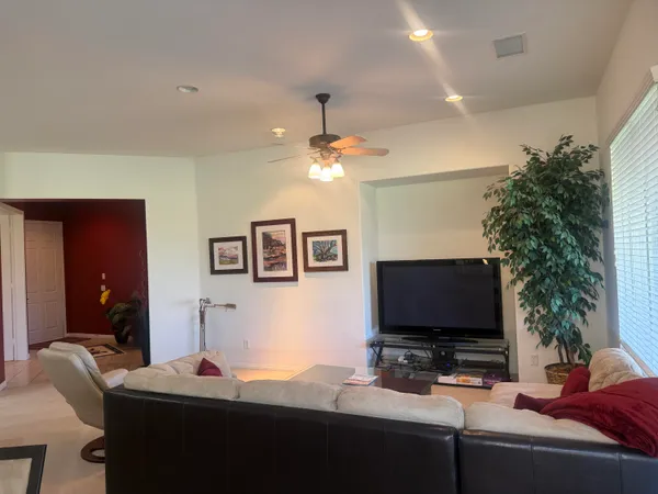 a bedroom with bed and a flat screen tv