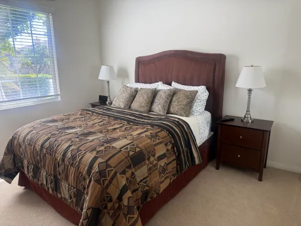 a bed sitting in a bedroom next to a window