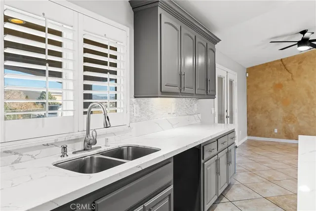 a kitchen with a sink refrigerator and cabinets