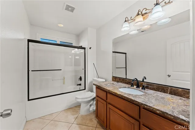 a view of an empty room with window and cabinet