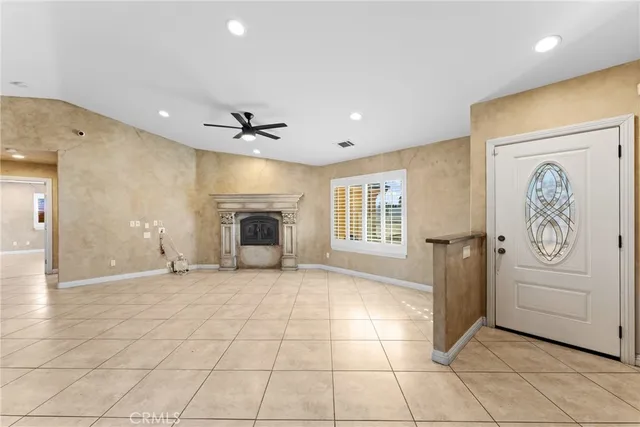 a view of an empty room with a fireplace