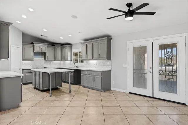 a view of a kitchen with furniture and a ceiling fan