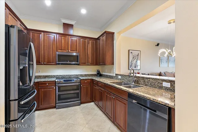 a kitchen with stainless steel appliances granite countertop a sink stove and refrigerator