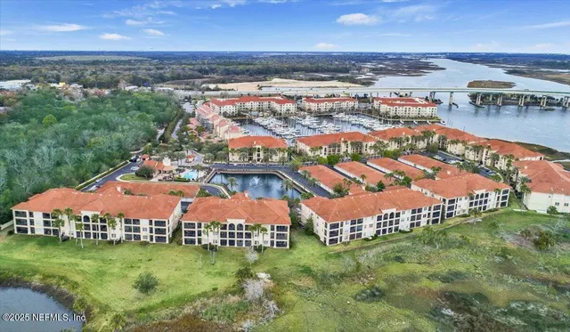 an aerial view of residential houses with outdoor space and river