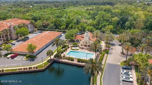 an aerial view of residential houses with outdoor space and swimming pool